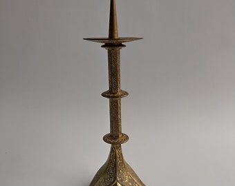 A French brass pricket candlestick with drip-tray, three splayed legs, neo-Gothic decor, possibly Limoges, late 19th — early 20th C.