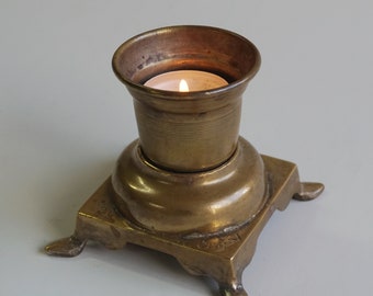 An intriguing small brass candlestick or candle holder from the Maghreb, featuring engraved Arabic texts