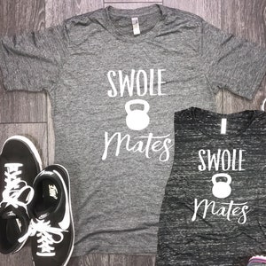 May include: Two gray and black shirts with the text "Swole Mates" and a white dumbbell icon.