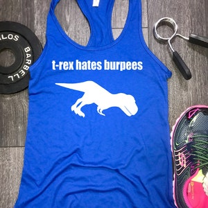 May include: A royal blue tank top with a white silhouette of a T-Rex and the text "t-rex hates burpees".