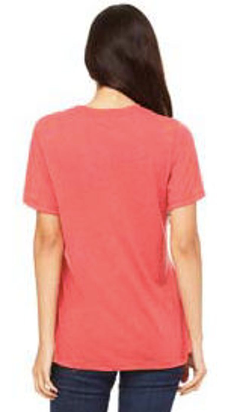 May include: A coral red short-sleeved t-shirt made of a soft, comfortable fabric. The shirt has a relaxed fit and a slightly distressed look.
