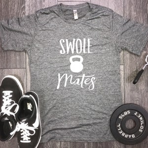 May include: Gray heather t-shirt with white text that reads "Swole Mates" with a white kettlebell graphic.