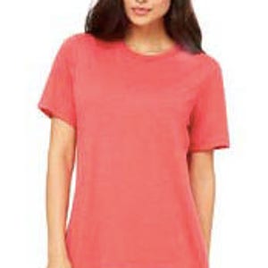 May include: A coral-colored short-sleeved t-shirt with a crew neck.