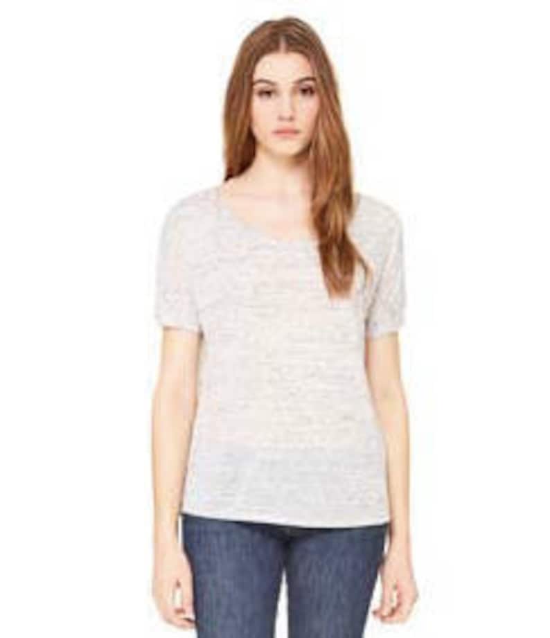 May include: A white short-sleeved t-shirt with a relaxed fit and a scoop neck.