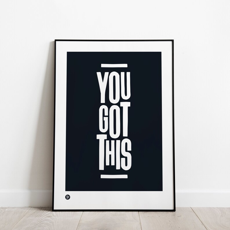 Art print from Love Type featuring the phrase You Got This in a black frame leaning against a white wall.