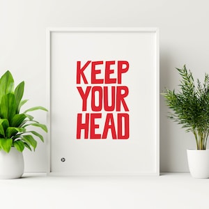 May include: White framed print with the text "KEEP YOUR HEAD" in bold red letters.