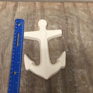 May include: White ceramic anchor figurine. The anchor is about 6 inches tall and is a popular nautical decor item.