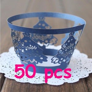 May include: Blue cupcake cases with a white cut-out design of Christmas trees. 50 pcs.