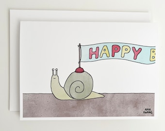 May include: A greeting card featuring a cartoon snail carrying a banner that reads "HAPPY BIRTHDAY". The snail is yellow and green, and the banner is blue with pink and yellow letters.