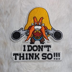 May include: Embroidered patch featuring a cartoon character with a large orange mustache and a yellow hat, holding two guns. The text "I DON'T THINK SO!!!" is below the character in black letters.