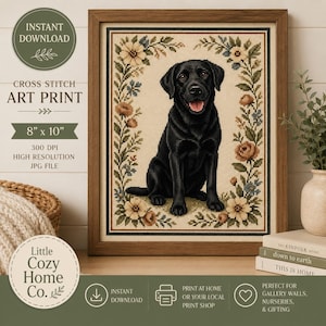 May include: A framed cross stitch art print featuring a black Labrador retriever sitting in the center, surrounded by a floral border of beige, brown, and blue flowers. The text on the image reads: INSTANT DOWNLOAD, CROSS STITCH ART PRINT, 8" x 10", 300 DPI HIGH RESOLUTION JPG FILE, Little Cozy Home Co.