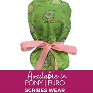 May include: A green scrub cap featuring a repeating pattern of cartoon gallbladders, some wearing superhero capes, and the text 99 problems but a GALLBLADDER ain't one! The cap is tied with a light pink ribbon at the back. The bottom text reads Available in PONY | EURO SCRIBES WEAR.