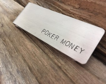 May include: A silver money clip with the words "Poker Money" engraved on the front.