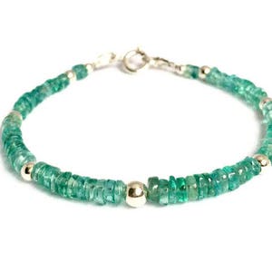 May include: A green gemstone bracelet with silver beads and a silver clasp.