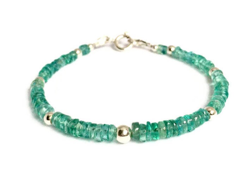May include: A green gemstone bracelet with silver beads and a silver clasp.