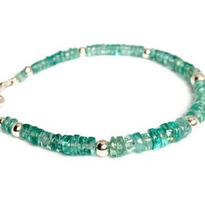 May include: A green gemstone bracelet with silver beads and a silver clasp.