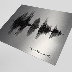 May include: A silver metal print with a black sound wave graphic and the text "I Love You. Daddy".