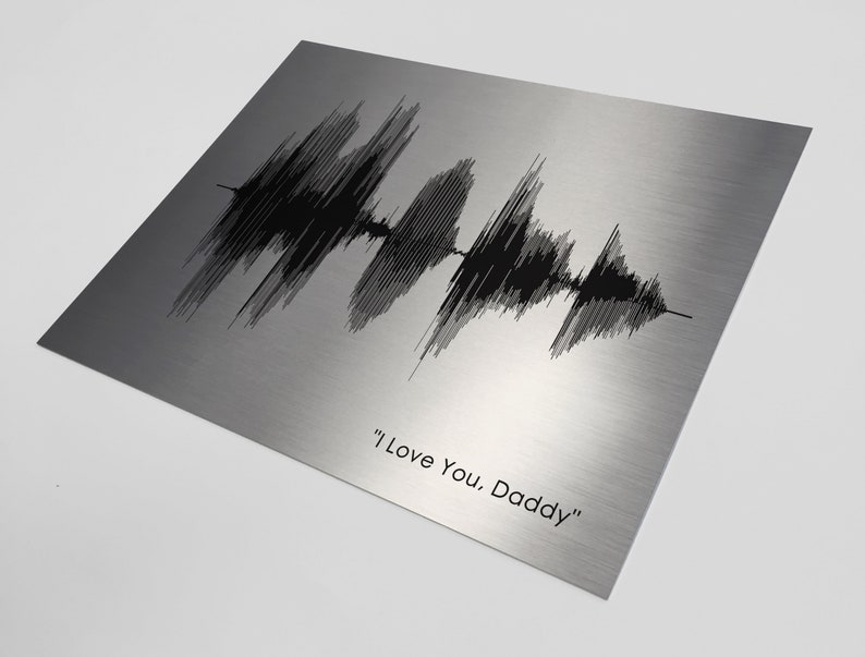May include: A silver metal print with a black sound wave graphic and the text "I Love You. Daddy".