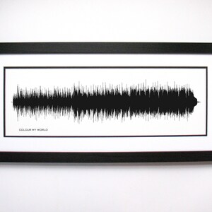 May include: A black and white framed print of a sound wave with the text "COLOUR MY WORLD" below it.