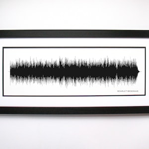 May include: A black and white framed print of a sound wave with the text "SCARLET BEGONIAS" at the bottom.