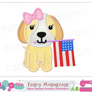 May include: A yellow puppy with a pink bow holding a small American flag. The puppy is wearing a white collar and has a purple stick in its mouth.