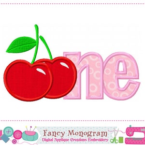 May include: Embroidered design featuring the word "one" in pink with a pink and white polka dot pattern inside the letters. Two red cherries with green stems and leaves are to the left of the word.
