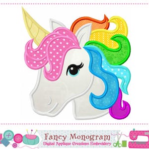 May include: An embroidered unicorn head design featuring a white face, a yellow horn, and a multi-colored mane with pink polka dots, orange, yellow, green, blue, and purple sections. The text reads Fancy Monogram Digital Applique Creations Embroidery.