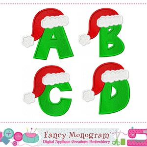May include: Four embroidered letters, A, B, C, and D, in green, each wearing a red Santa hat with white trim. The image is a digital applique design with the text "Fancy Monogram" and "Digital Applique Creations Embroidery".