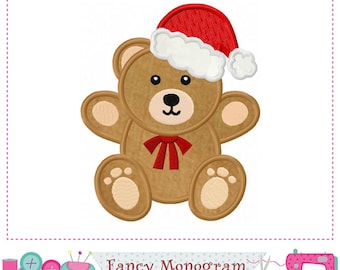 May include: A brown teddy bear wearing a red Santa hat with white trim and a red bow. The bear has black eyes and a black nose. The image is a digital applique design.