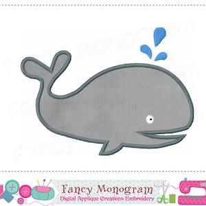 May include: A gray whale with a blue water splash above it. The whale has a white eye and a smiling mouth. The image is a digital embroidery design.