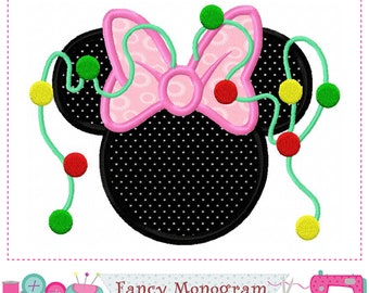 May include: A black and white polka dot Mickey Mouse head with a pink bow and green and red Christmas lights.