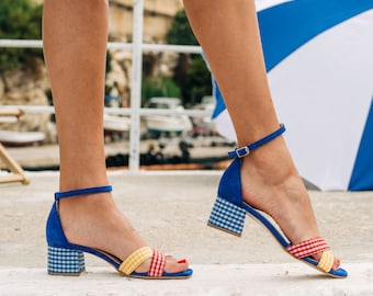 checked playful blue women shoes ,medium heels in blue ,red and yellow checked fabric.Criss cross unique shoes with ankle strap.women heels