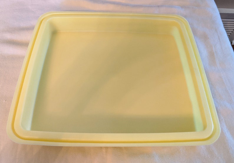 Op de afbeelding: Een gele bakvorm met een dubbele rand. De vorm is gemaakt van glad, anti-aanbakmateriaal.