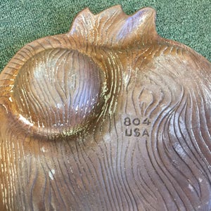 Puede incluir: Un plato de servir de cer&aacute;mica marr&oacute;n con un patr&oacute;n de veta de madera. El plato tiene dos secciones hundidas y las palabras "804 USA" est&aacute;n estampadas en la parte inferior.