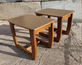 May include: Two wooden end tables with curved legs and a rectangular top. The tables are made of a dark brown wood and are in good condition.