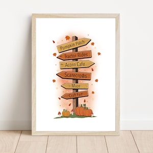 May include: Framed print of a signpost with arrows pointing to a pumpkin patch, tractor rides, acorn cafe, scarecrows, maze, and craft fair. The artwork has a fall theme with pumpkins and falling leaves.