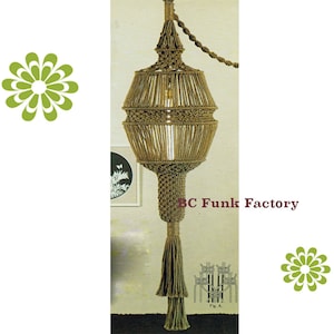 May include: A macrame hanging lamp with a brown rope and a tassel. The lamp is hanging from a chain and has a light bulb inside. The text "BC Funk Factory" is visible in the image.