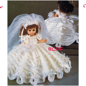 May include: Two white crocheted doll dresses with lace trim and satin ribbon accents. The dresses are designed for a doll with a long white veil.