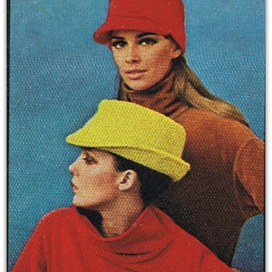 May include: Two women wearing hats. The woman in the front is wearing a yellow hat and a red sweater. The woman in the back is wearing a red hat and a brown sweater.