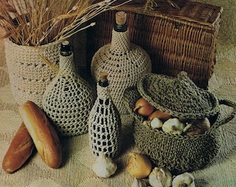 May include: Crocheted covers for bottles and a basket filled with onions and garlic. The covers are made with a beige yarn and the basket is made with a brown yarn.