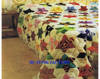 May include: A crocheted blanket with a star pattern in various colors, including pink, green, blue, and yellow. The blanket is made of a soft, textured yarn and has a fringe border.