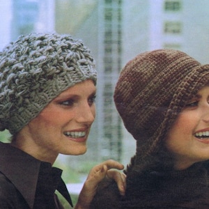 May include: Two women wearing knitted hats. The woman on the left is wearing a grey slouchy beanie. The woman on the right is wearing a brown cloche hat.