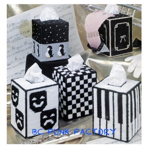 May include: Five different tissue box covers with black and white designs. The designs include penguins, musical notes, checkerboard, piano keys, and theater masks.