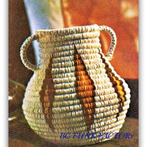 May include: A white and brown woven vase with two handles. The vase has a geometric pattern with brown stripes.
