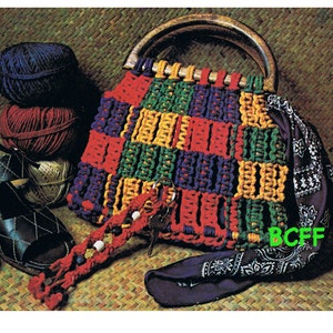 May include: A colorful crocheted bag with a wooden handle. The bag is made with red, yellow, green, and purple yarn. The bag is sitting on a woven mat with a bandana and yarn balls.