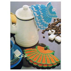 May include: Two crocheted tea cozy covers in the shape of dresses. One is blue and white and the other is orange and green.