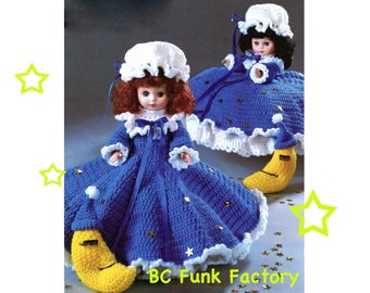 May include: Two dolls wearing blue crocheted nightgowns with white trim and yellow crescent moon pillows. The nightgowns are decorated with silver glitter stars. The dolls are wearing white crocheted hats. The image includes the text "BC Funk Factory".