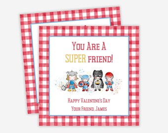 Könnte beinhalten: Rote und weiße karierte Karte mit blauem Rand. Die Karte sagt "Du bist ein super Freund!" mit einer Gruppe von Comic-Superhelden. Die Karte sagt auch "Frohen Valentinstag" und "Dein Freund, James".
