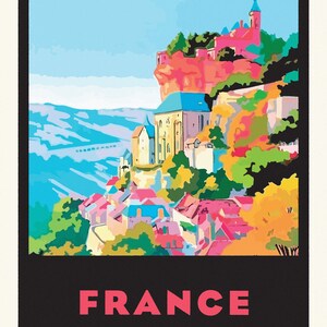 May include: A colorful illustration of a French village nestled on a cliffside, with a church steeple and surrounding buildings. The text "FRANCE" is printed in pink at the bottom of the image.