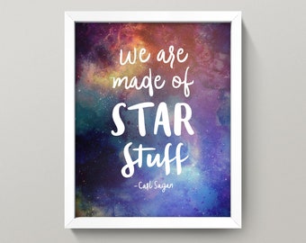 May include: A white framed print with a colorful galaxy background and the quote "We are made of STAR stuff - Carl Sagan".